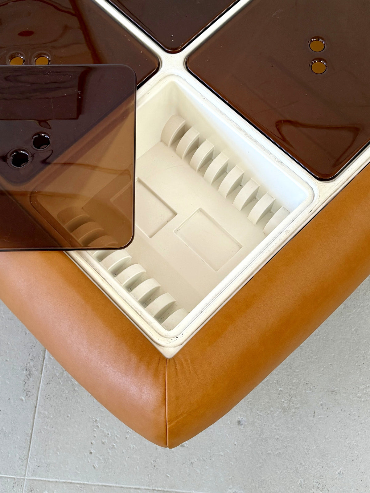 Detail of open storage compartment on the Nuvolone coffee table, showing lucite lid